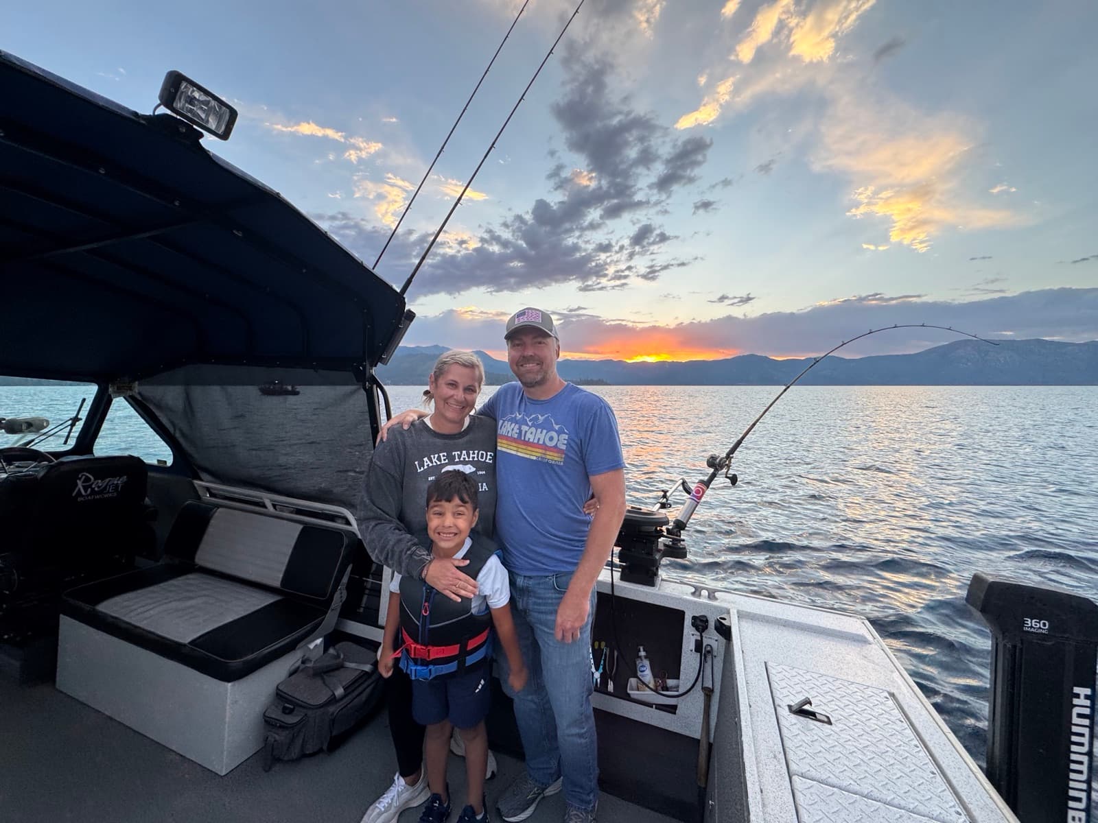 Kenny Buelterman with his wife Jackie and son Fisher on a boat at sunset